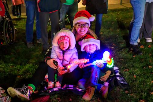 Two year old Zella, on left, and her 4 year old brother Zackary wait patiently with their mother Sarah Pratt for Sant to arrive to light the Town Christmas tree.